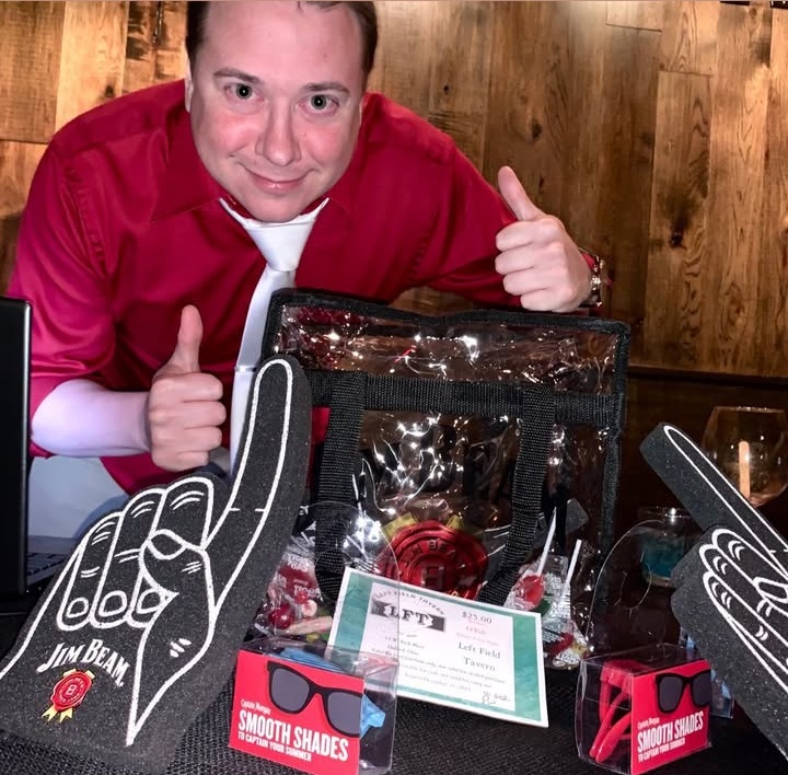 A trivia-night winner with a stuffed prize bag at O'Pub.